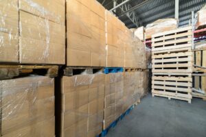 Rows of Pallets wrapped in plastic film wrap.